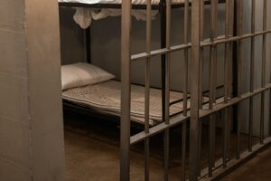 jail cell with bed and pillow