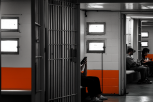 men waiting in orange waiting room to speak with bail bondsman